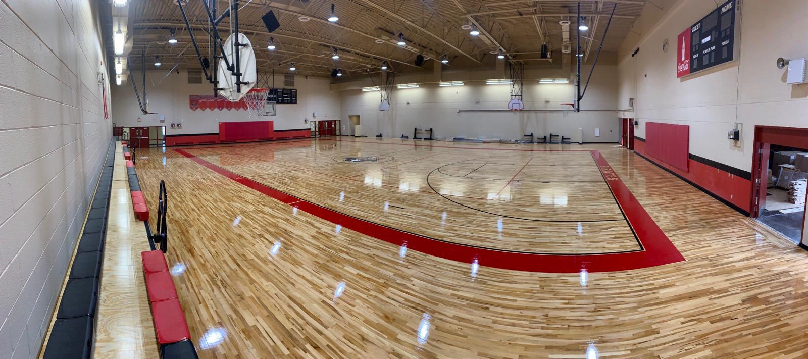 Refinished maple basketball court with painted game lines